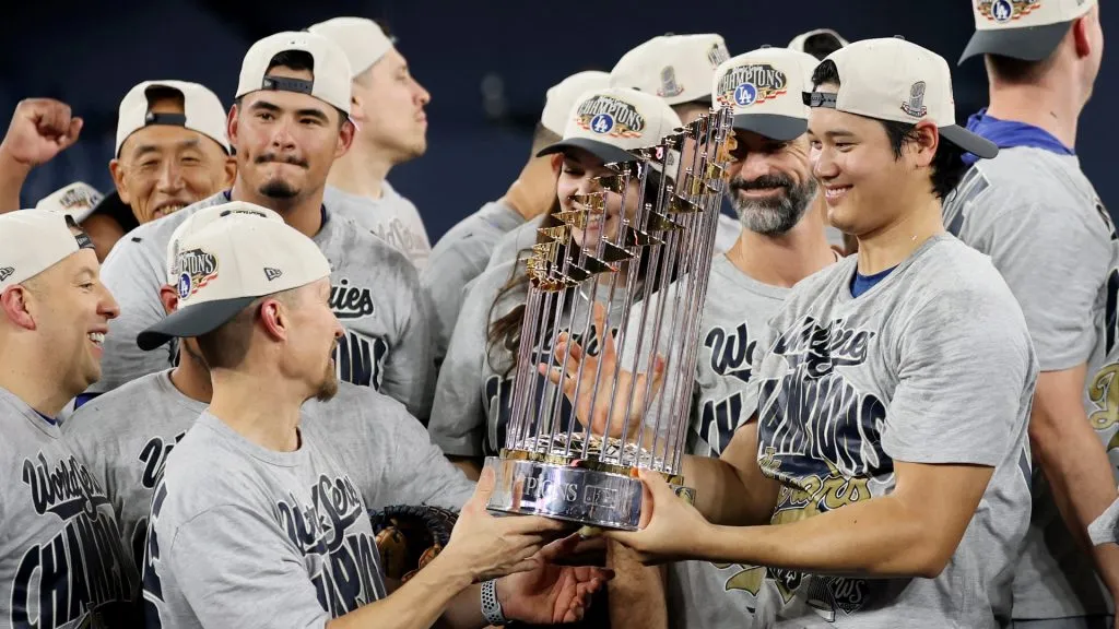 Shohei Ohtani #17 of the Dodgers holds the Commisioner’s Trophy after defeating the Blue Jays. Emilee Chinn/Getty Images