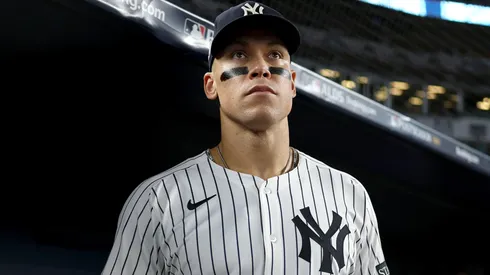 Aaron Judge #99 of the New York Yankees looks on in the dugout.