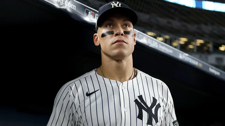 Aaron Judge #99 of the New York Yankees looks on in the dugout.
