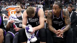 DeMar DeRozan #10, Domantas Sabonis #11, and Zach LaVine #8 of the Sacramento Kings sit.