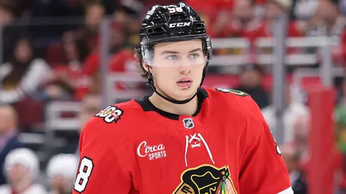 Connor Bedard #98 of the Chicago Blackhawks looks on in an NHL game.
