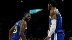 Draymond Green #23 of the Golden State Warriors reacts to Jonathan Kuminga #1.