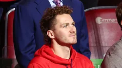 Matthew Tkachuk watches from behind the Florida Panthers bench at Amerant Bank Arena