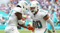 Alec Ingold #30 of the Miami Dolphins celebrates with a teammate in 2025.