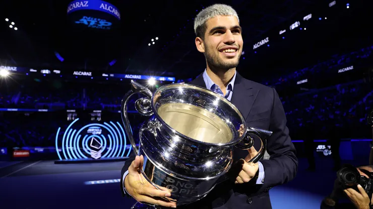 Carlos Alcaraz holds the 2025 Year-End ATP World No.1 Trophy.