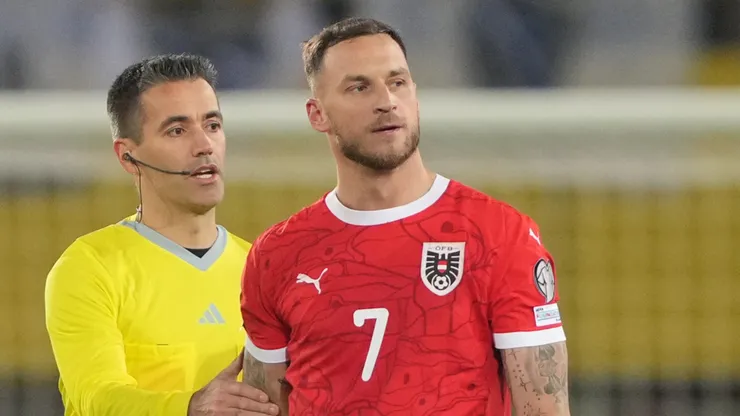 Marko Arnautovic of Austria is shown a yellow card.