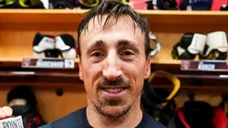 Brad Marchand poses for a picture after recording his 1,000th NHL point