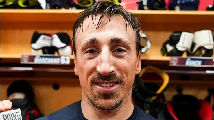Brad Marchand poses for a picture after recording his 1,000th NHL point