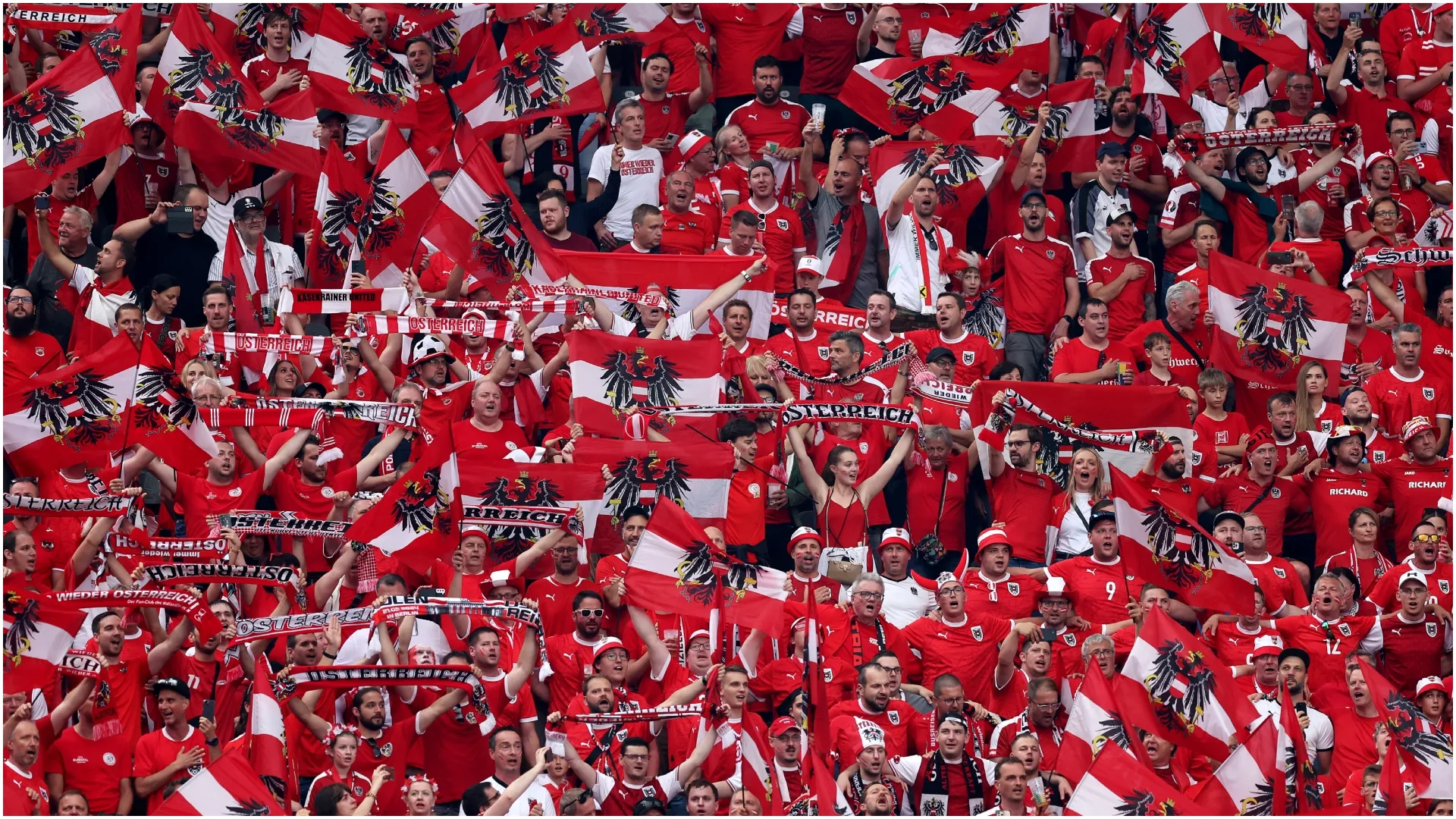 Austria fans hold up national flags – Julian Finney/Getty Images
