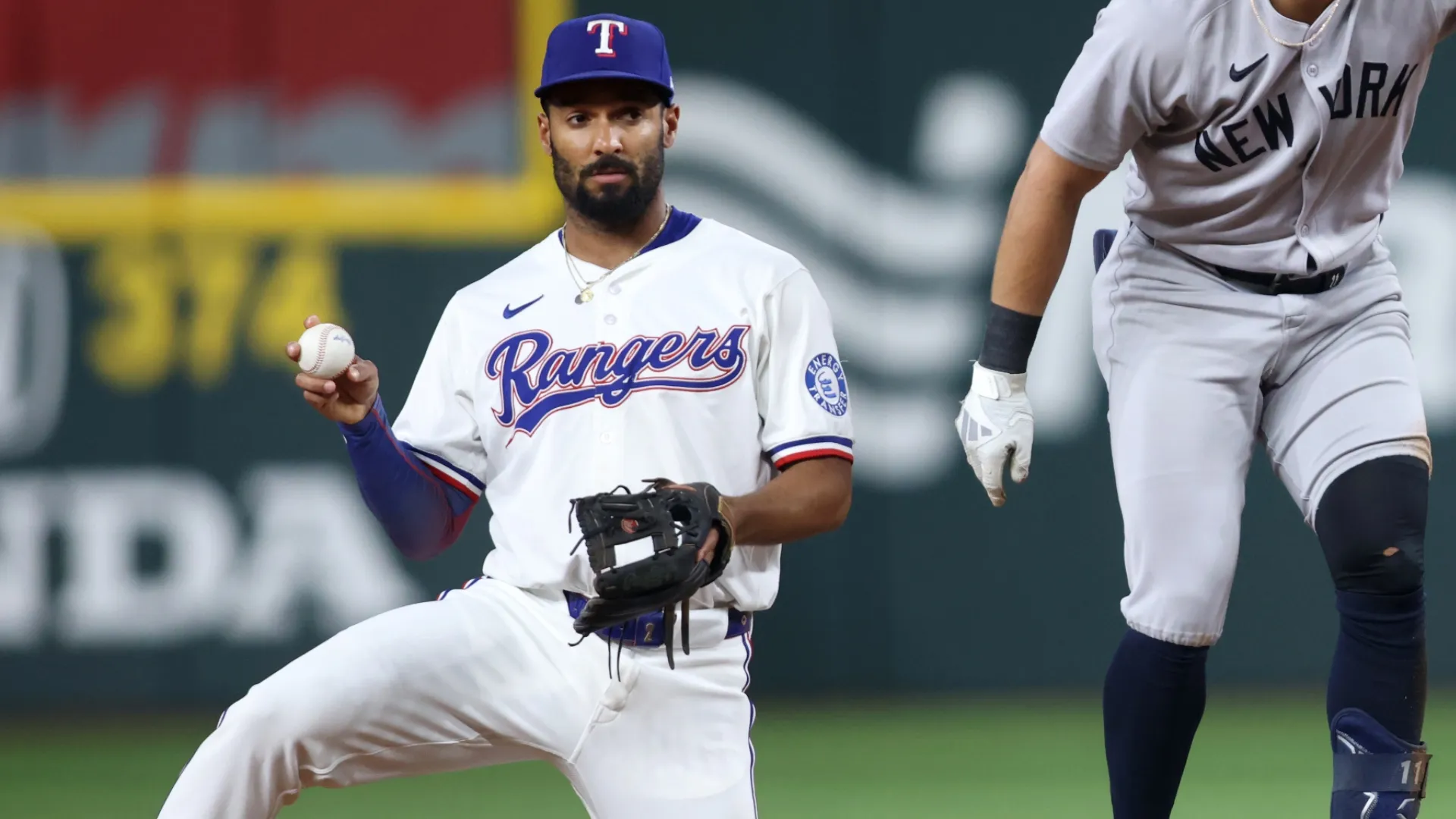 Marcus Semien #2 of the Texas Rangers holds the ball. Tim Heitman/Getty Images