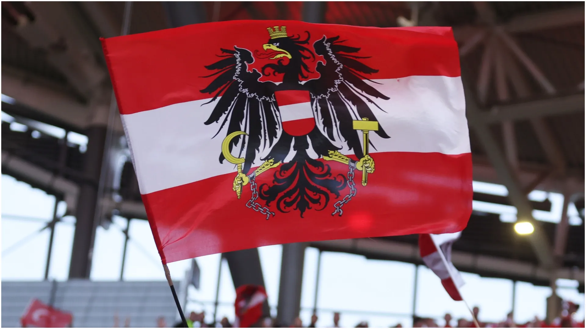 Fan of Austria waves a national flag – Lars Baron/Getty Images