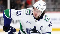 Quinn Hughes #43 of the Canucks skates against the Panthers.