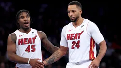 Davion Mitchell and Norman Powell react during an NBA game.