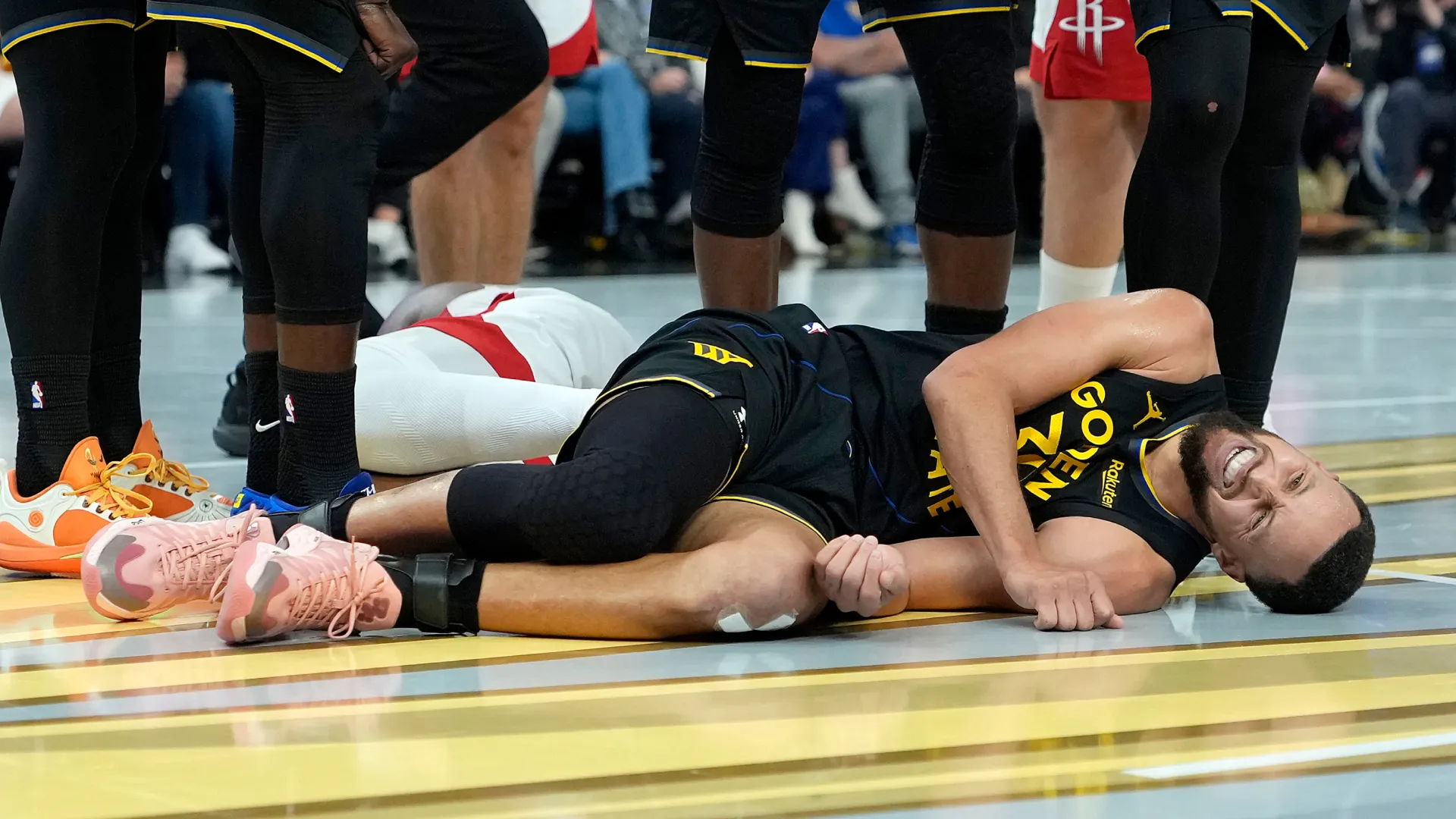Stephen Curry lays on the floor in pain. (Getty Images)