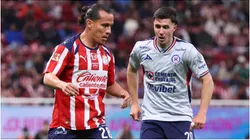 Fernando Gonzalez of Chivas controls the ball ahead of Jose Paradela of Cruz Azul