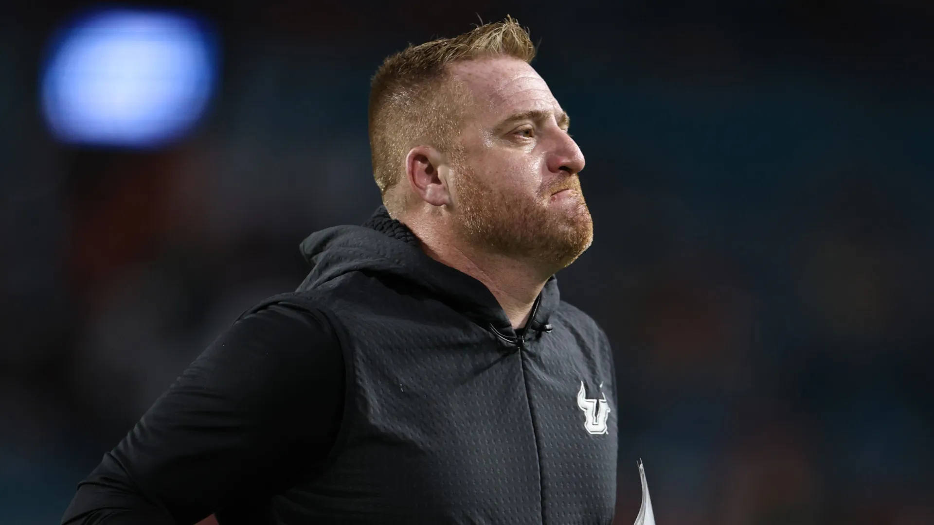 Alex Golesh runs off the field