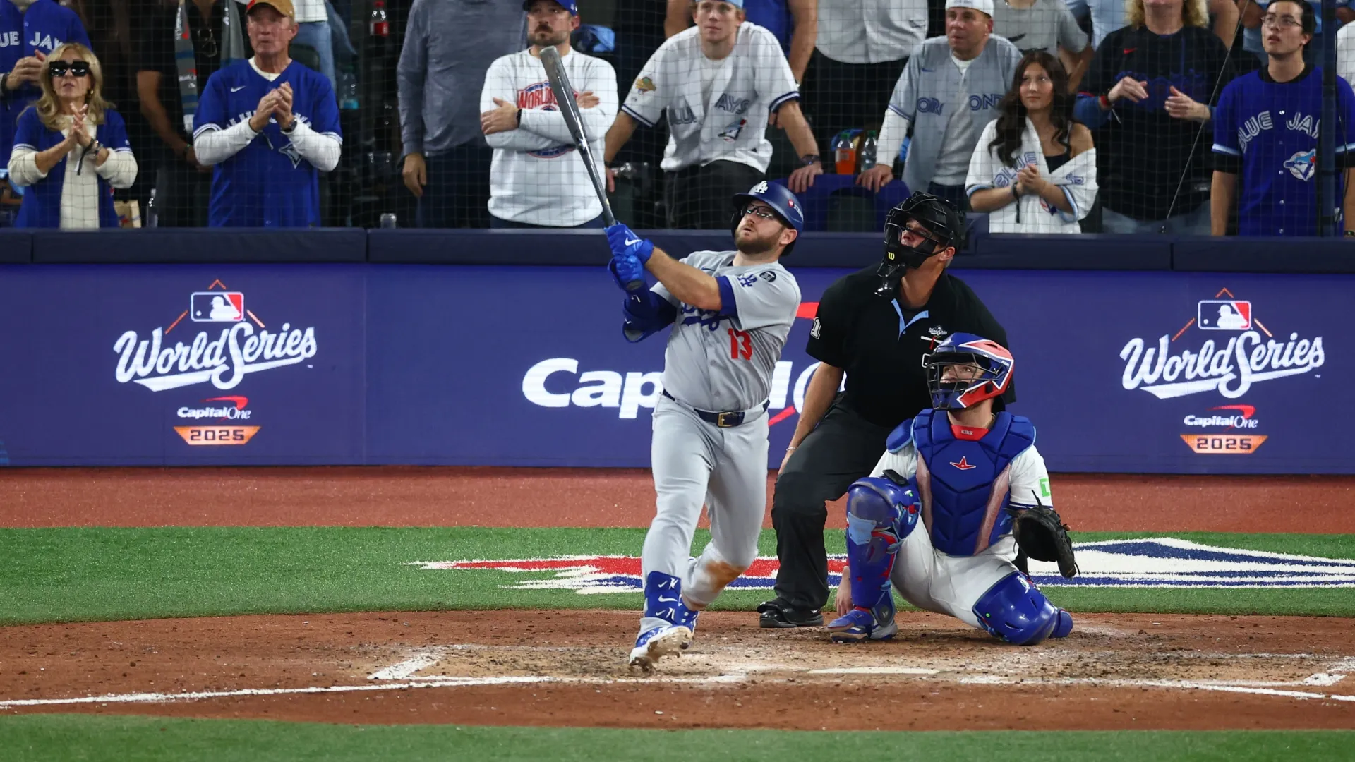 Max Muncy #13 of the Dodgers hits a home run against the Blue Jays. Vaughn Ridley/Getty Images