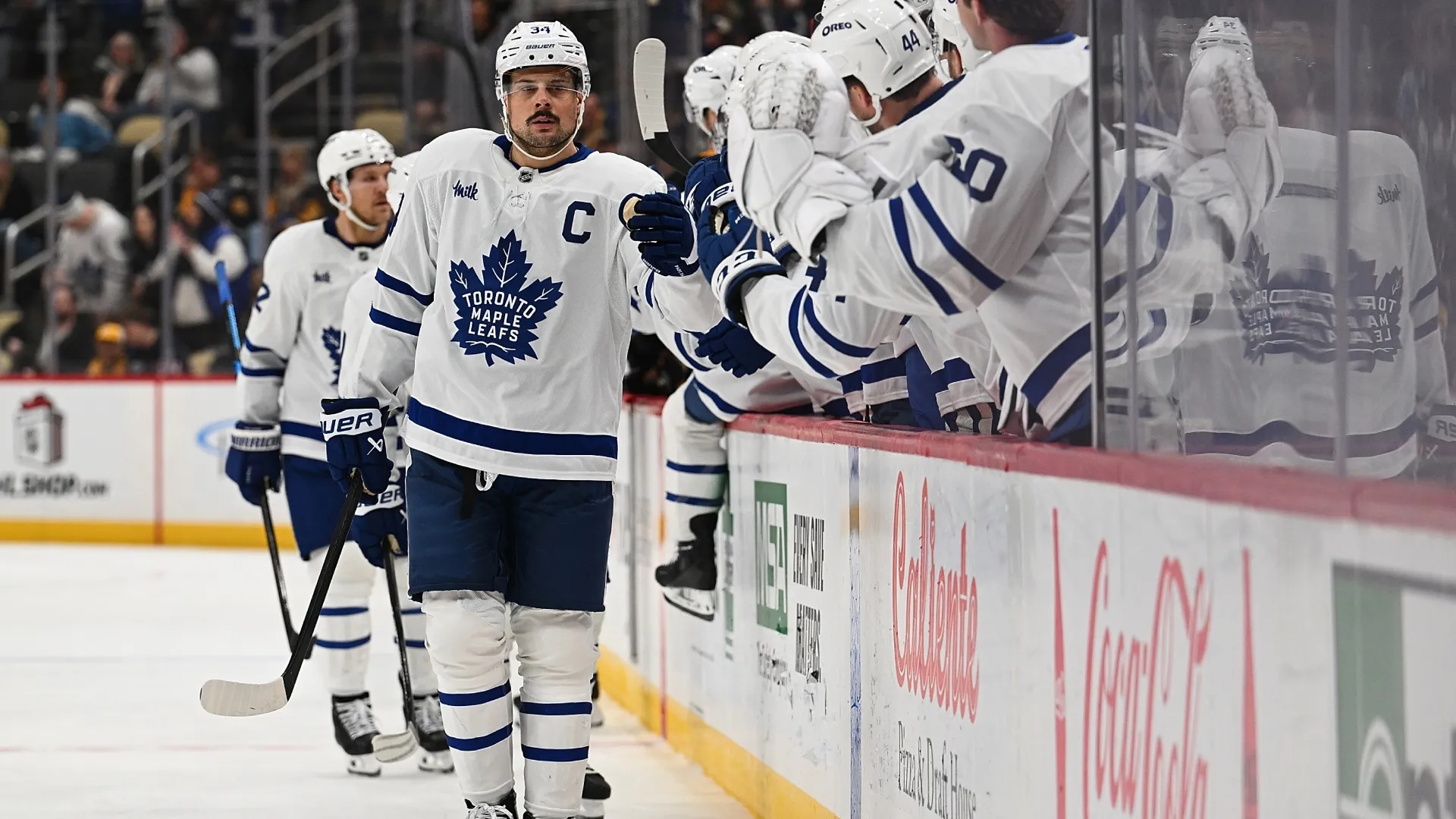 Auston Matthews #34 of the Maple Leafs celebrates with teammates on the bench after scoring a goal. Justin Berl/Getty Images