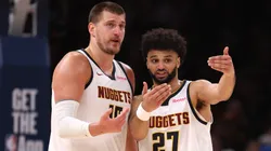 Nikola Jokic and Jamal Murray talk during a game.