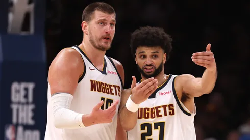 Nikola Jokic and Jamal Murray talk during a game.