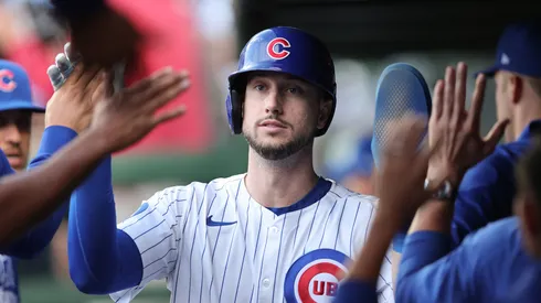 Kyle Tucker #30 of the Chicago Cubs high-fives teammates.