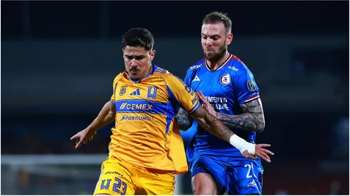Romulo Zwarg of Tigres competes for the ball against Carlos Rotondi of Cruz Azul