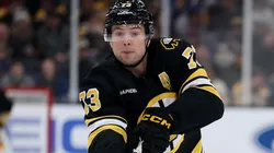 Charlie McAvoy #73 of the Boston Bruins passes the puck.