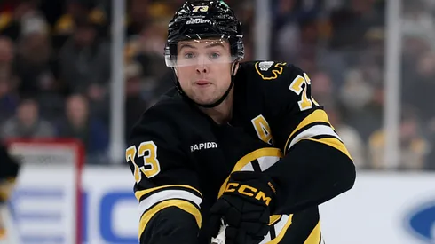 Charlie McAvoy #73 of the Boston Bruins passes the puck.