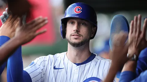 Kyle Tucker #30 with the Chicago Cubs high-fives teammates in the dugout.