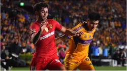 Santiago Simon of Toluca battles for possession against Marco Farfan of Tigres