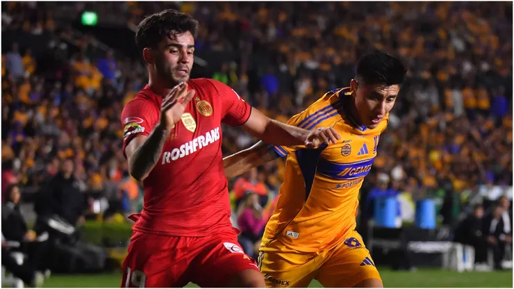 Santiago Simon of Toluca battles for possession against Marco Farfan of Tigres