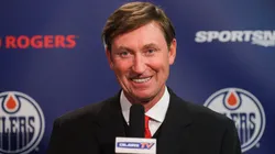 Wayne Gretzky gives a press conference between periods during an NHL game.