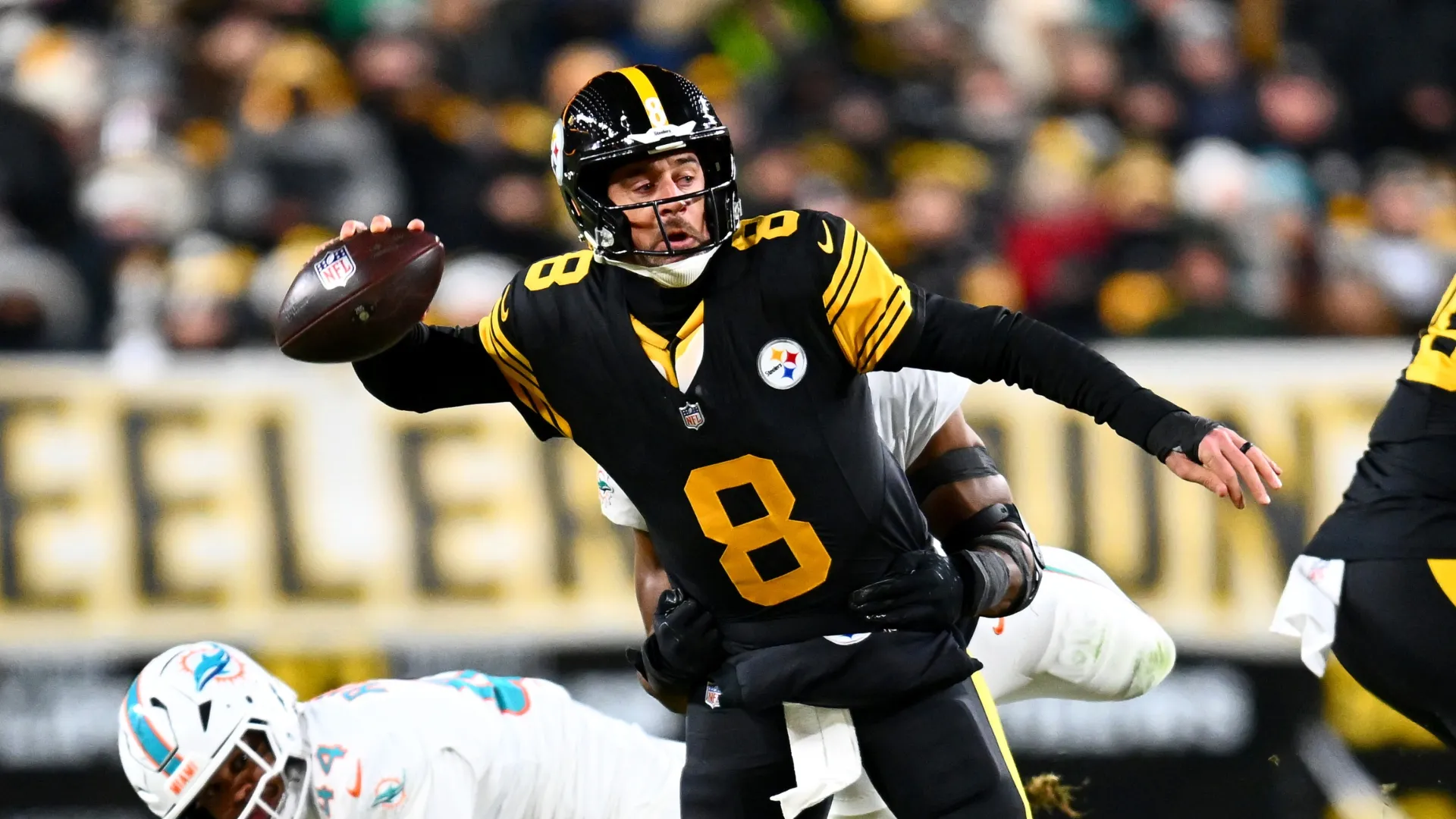 Aaron Rodgers being sacked by Jordyn Brooks