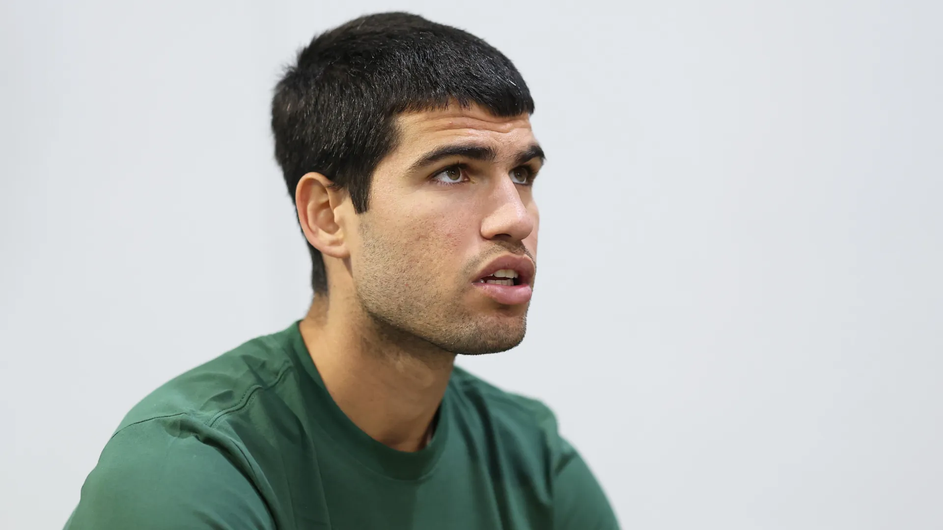 Carlos Alcaraz stares at something