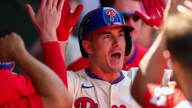 J.T. Realmuto #10 of the Philadelphia Phillies celebrates with teammates in the dugout.