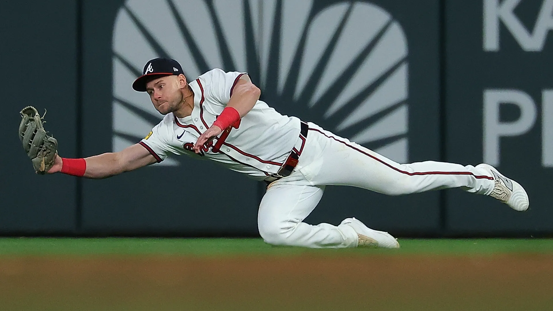 Jarred Kelenic #24 with the Braves dives and catches a line out. Kevin C. Cox/Getty Images