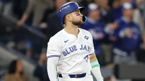 Bo Bichette #11 of the Toronto Blue Jays hits a three-run home run.
