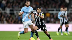 Bruno Guimaraes of Newcastle United is put under pressure by Nico Gonzalez of Manchester City.
