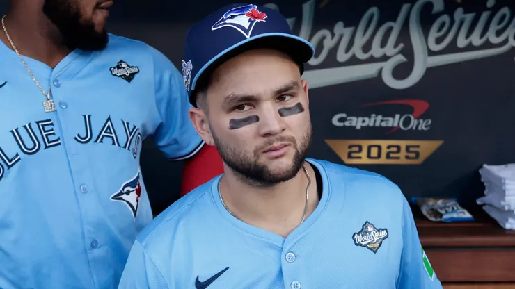 Bo Bichette #11 with the Blue Jays looks on from the dugout.