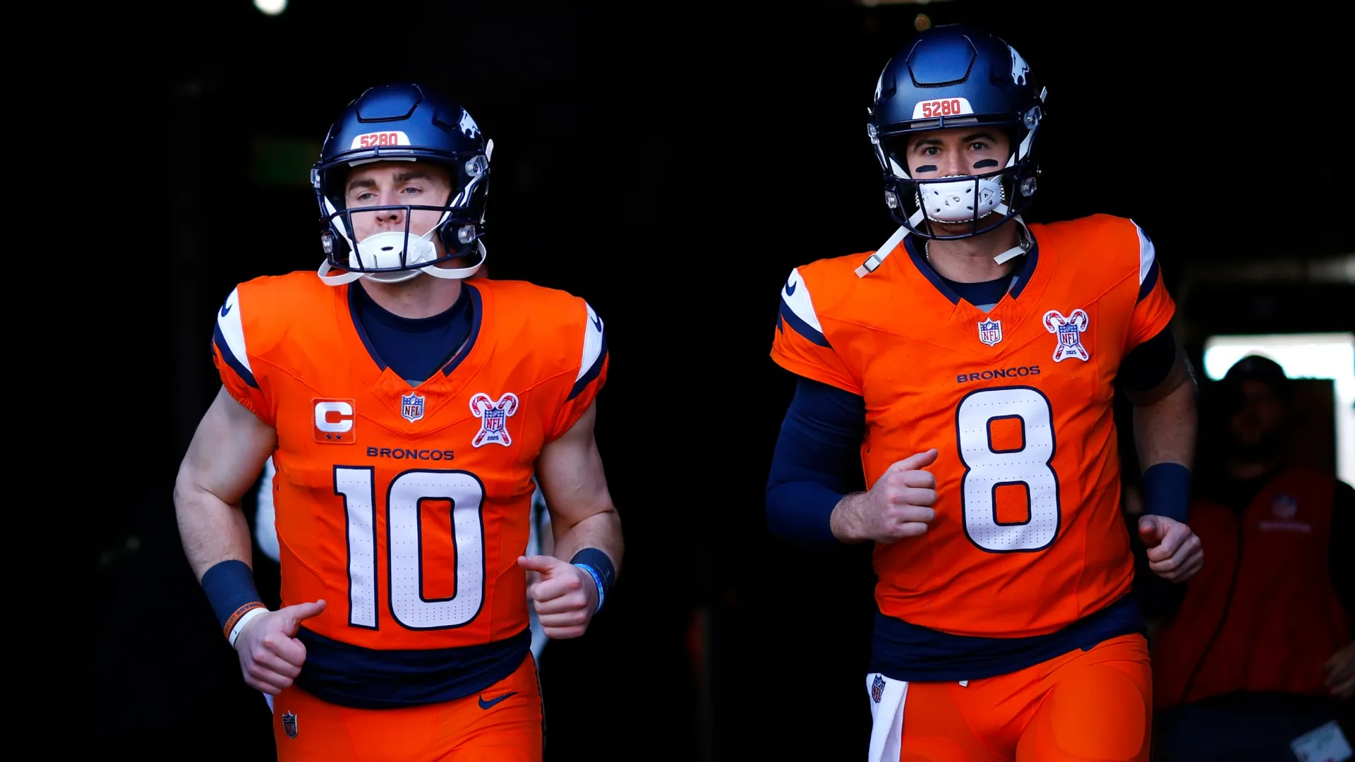 Bo Nix (left) and Jarrett Stidham walking into the field.