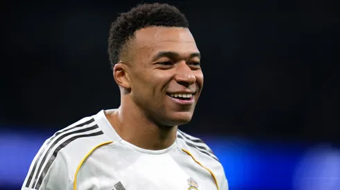 Kylian Mbappe smiles during a Champions League game.
