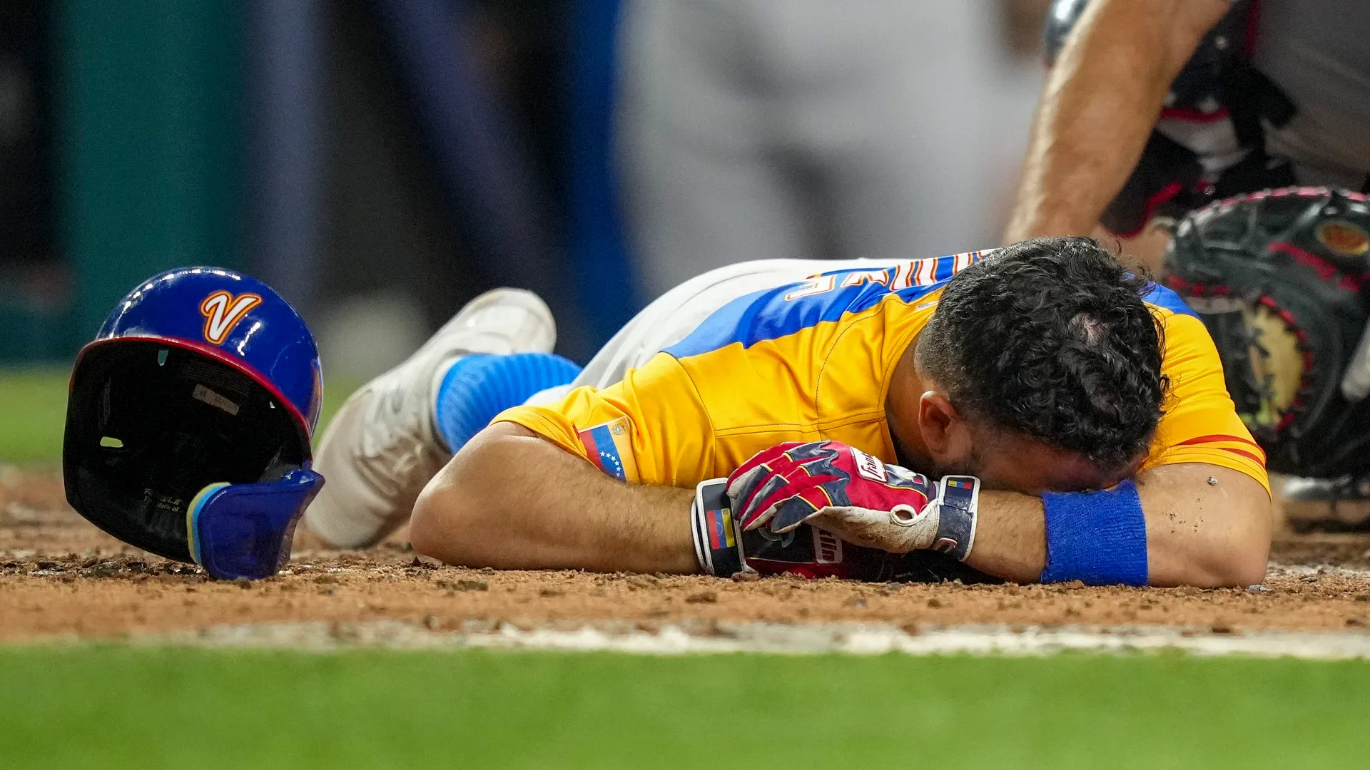 Jose Altuve  lies on the ground after being hit by a pitch during the 2023 World Baseball Classic on March 18, 2023 in Miami. (Eric Espada/Getty Images)