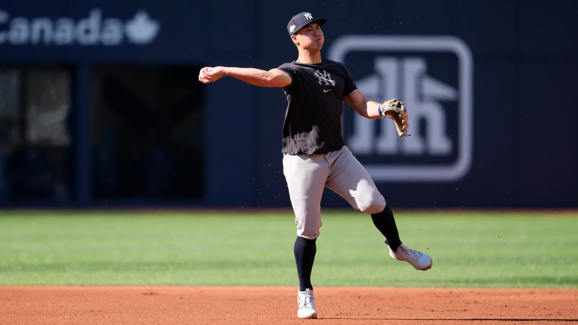 Anthony Volpe #11 of the Yankees warms up before game two against the Blue Jays. Mark Blinch/Getty Images