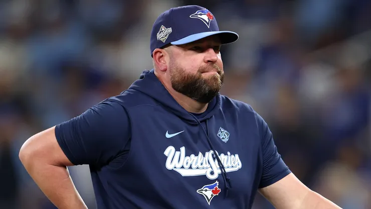 John Schneider #14 of the Toronto Blue Jays walks.