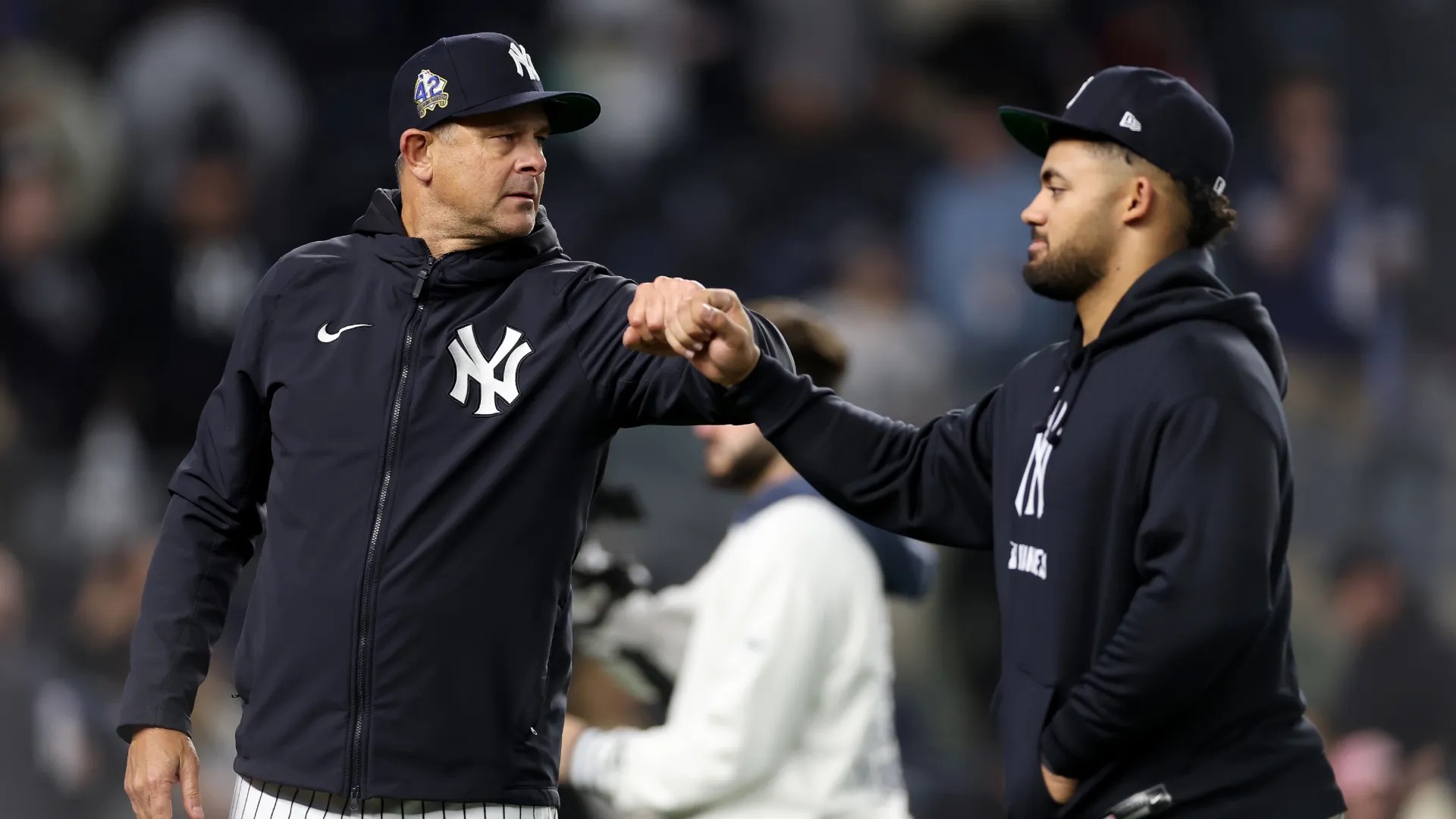 Aaron Boone #17 of the Yankees celebrates the win with Jasson Domínguez #24 after the game. Elsa/Getty Images