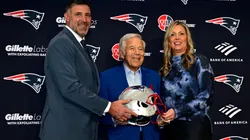 Owner Robert Kraft poses for a photograph with Mike Vrabel and his wife Jen Vrabel in 2025.