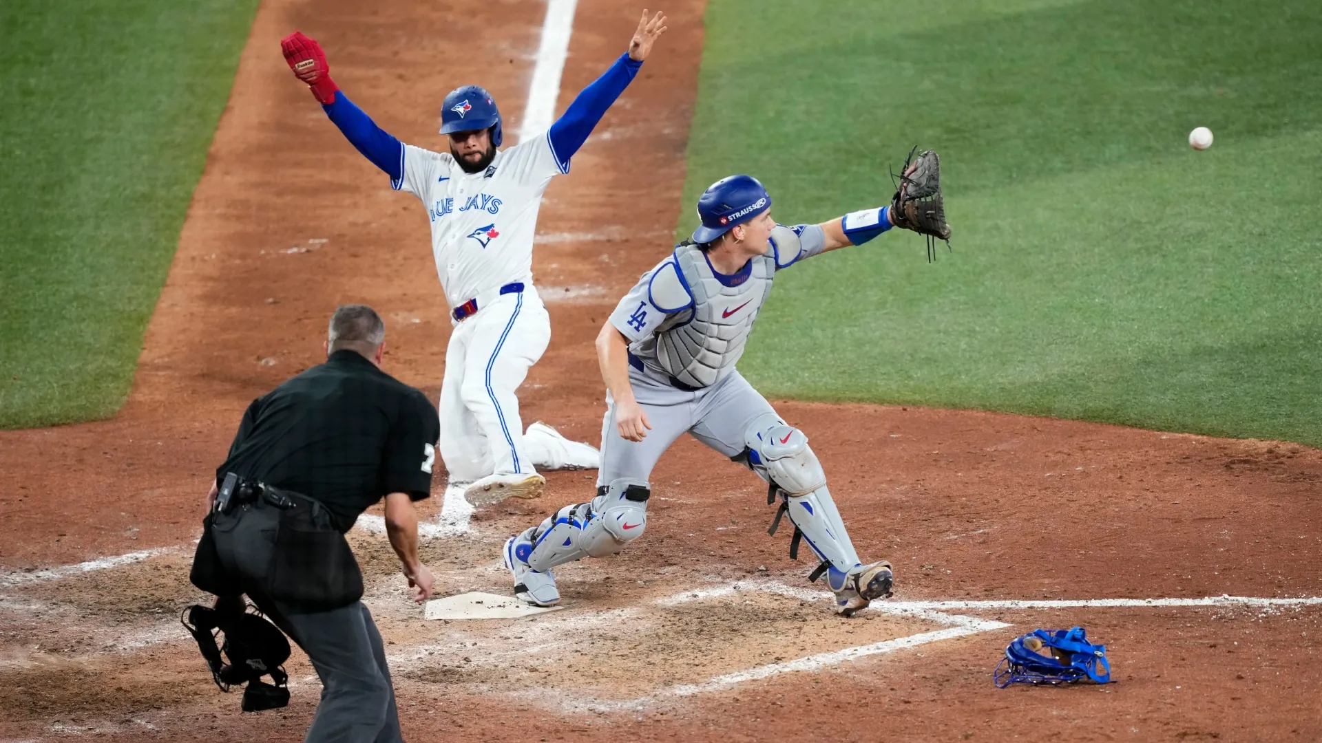 Isiah Kiner‑Falefa (#7) with the Blue Jays is tagged out at home plate. Mark Blinch/Getty Images