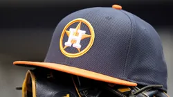 A hat and glove rest in the Astros’ dugout before a game at Miller Park.