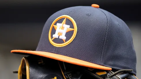A hat and glove rest in the Astros’ dugout before a game at Miller Park.