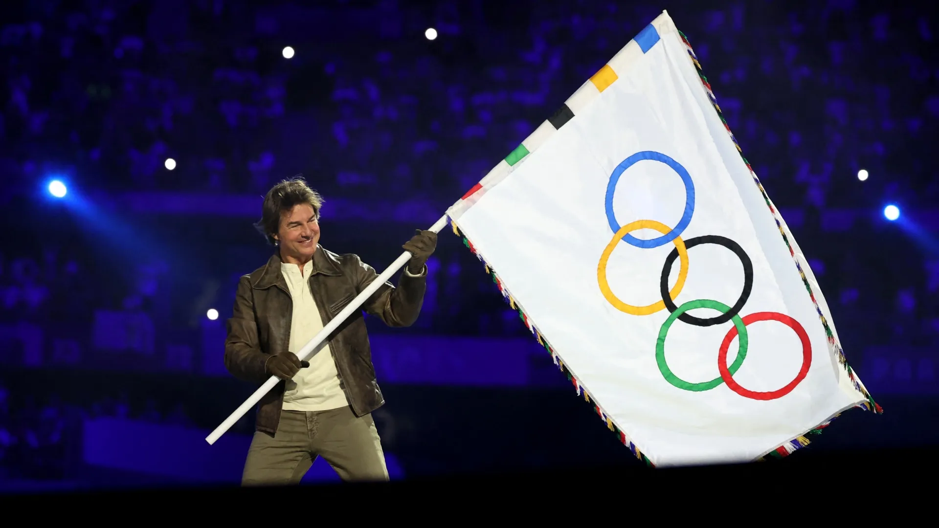 Tom Cruise holds the Olympic flag during the Closing Ceremony of the Olympic Games Paris 2024 (Source: Fabrizio Bensch- Pool/Getty Images)